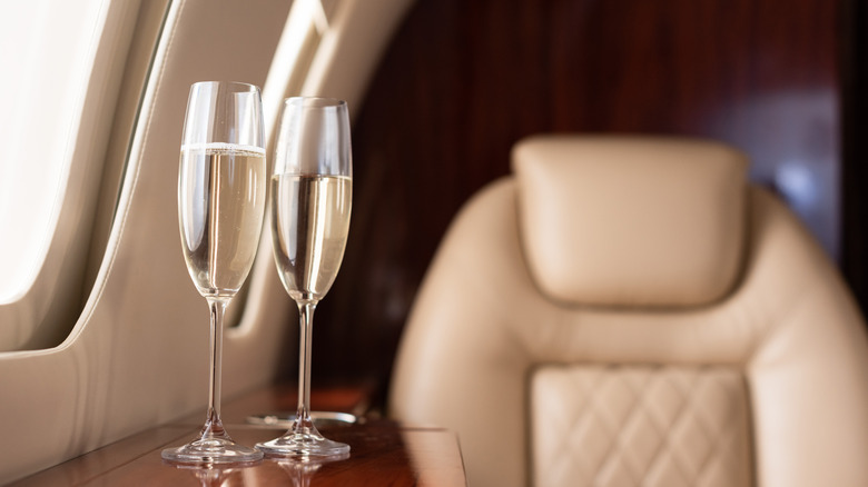 two sparkling wine glasses on airplane