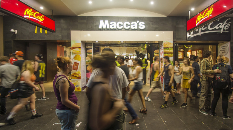 people walking by a McDonald's temporarily rebranded as Macca's