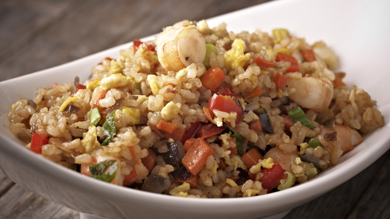 fried rice with vegetables and seafood in a dish
