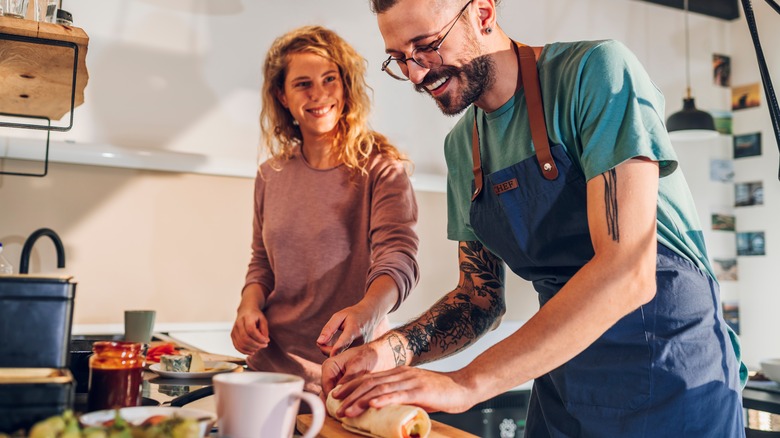 couple making breakfast burritos