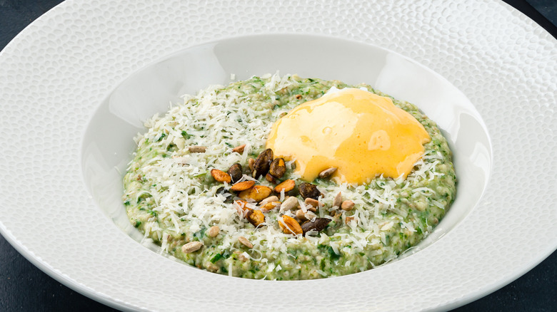 Oatmeal with cheese and herbs in a bowl