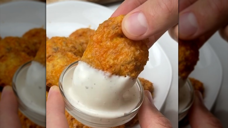 Rotisserie chicken nuggets dipped in sauce