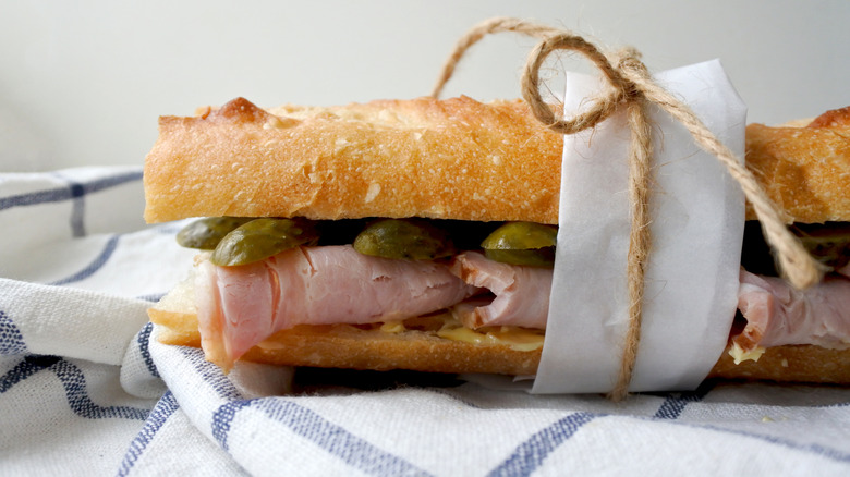 French jambon-beurre sandwich with cornichons wrapped with twine