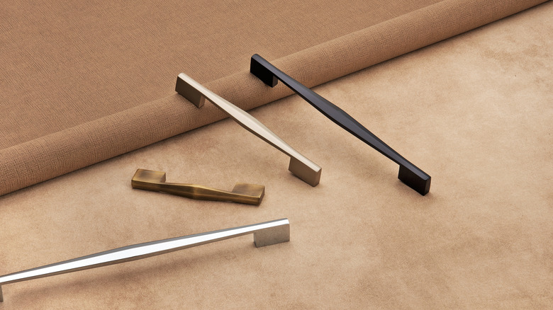 Various cabinet pulls on carpet and flooring