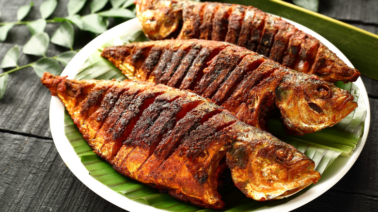 three grilled whole fish