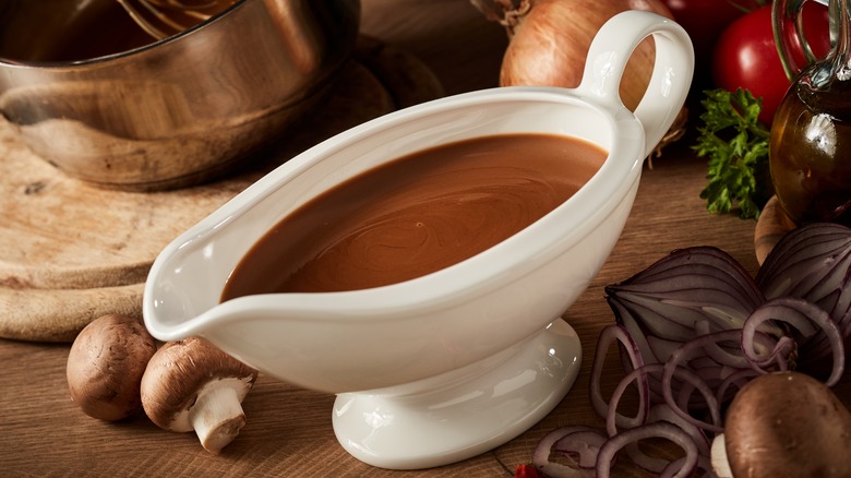 Gravy in gravy boat with ingredients surrounding