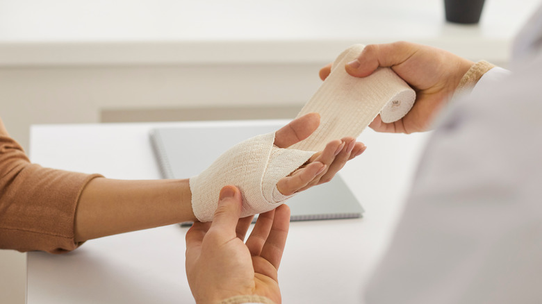 hands being bandaged