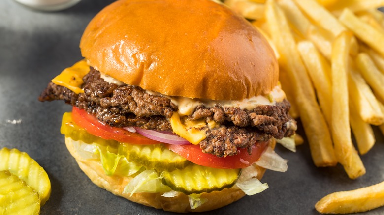 Smashburger with toppings and fries
