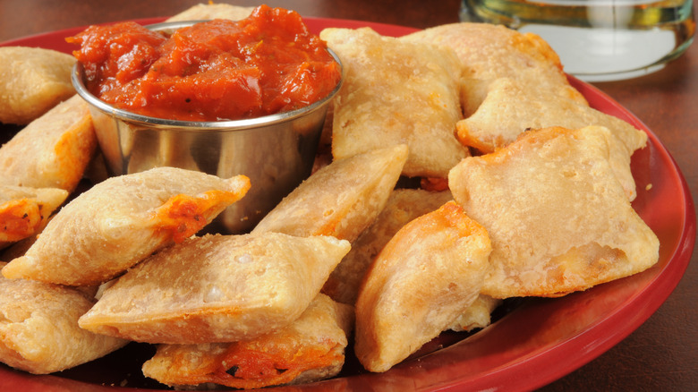 Pizza rolls on a red plate