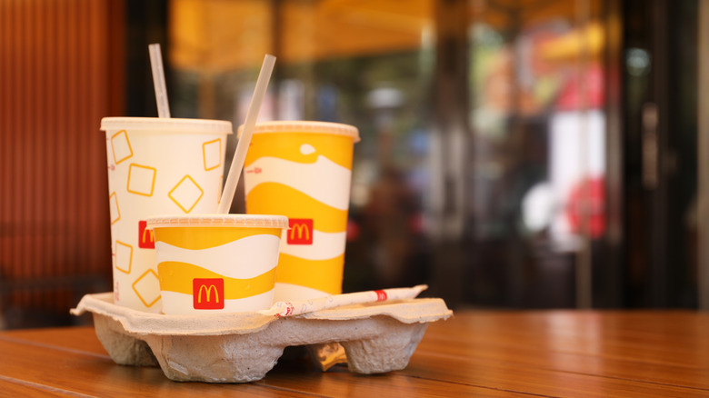 assorted McDonald's cups with straws