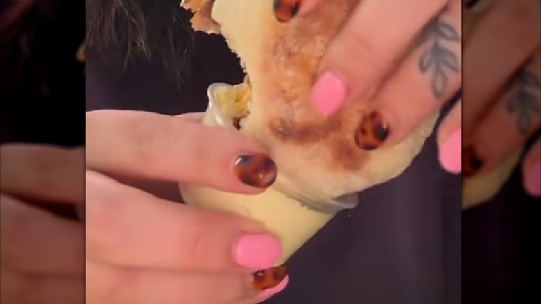 Dipping a sausage McMuffin in McDonald's breakfast sauce