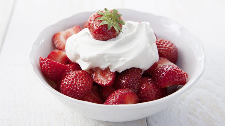 bowl of strawberries with whipped cream