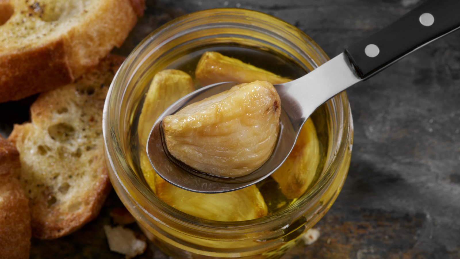 Your Slow Cooker Is The Secret To Roasted Garlic That Won't Burn