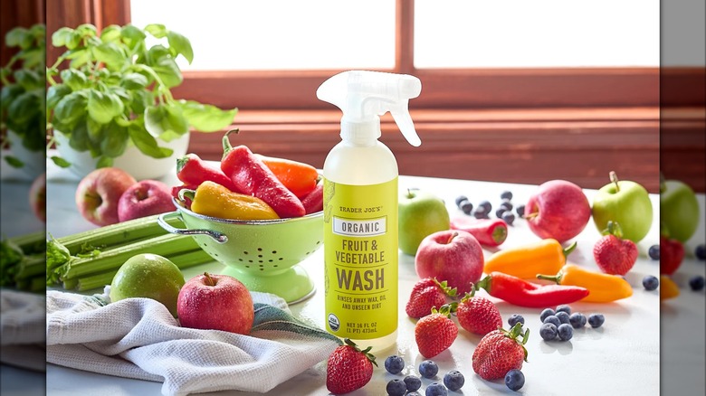 Spray bottle of Trader Joe's organic fruit & vegetable wash with produce