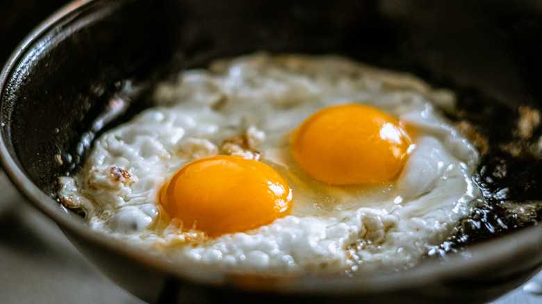 Frying eggs in pan of hot oil