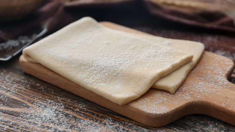 raw puff pastry dough on board