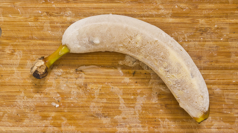 frozen banana on cutting board