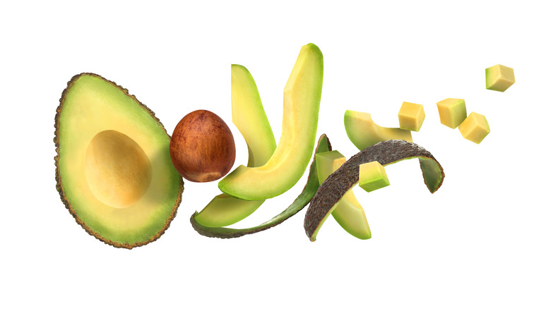 Sliced avocado tumbling through air