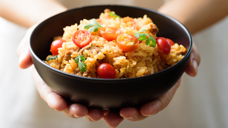 Person holding a rice bowl