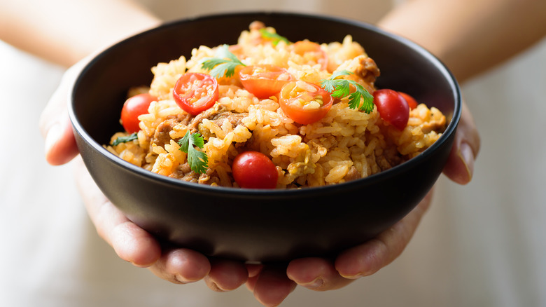 Person holding a rice bowl