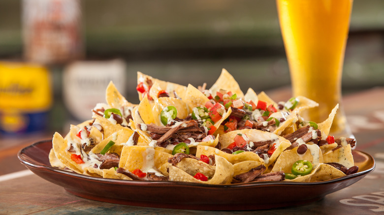 plate of nachos and beer