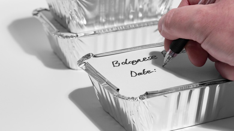 man labeling food to freeze